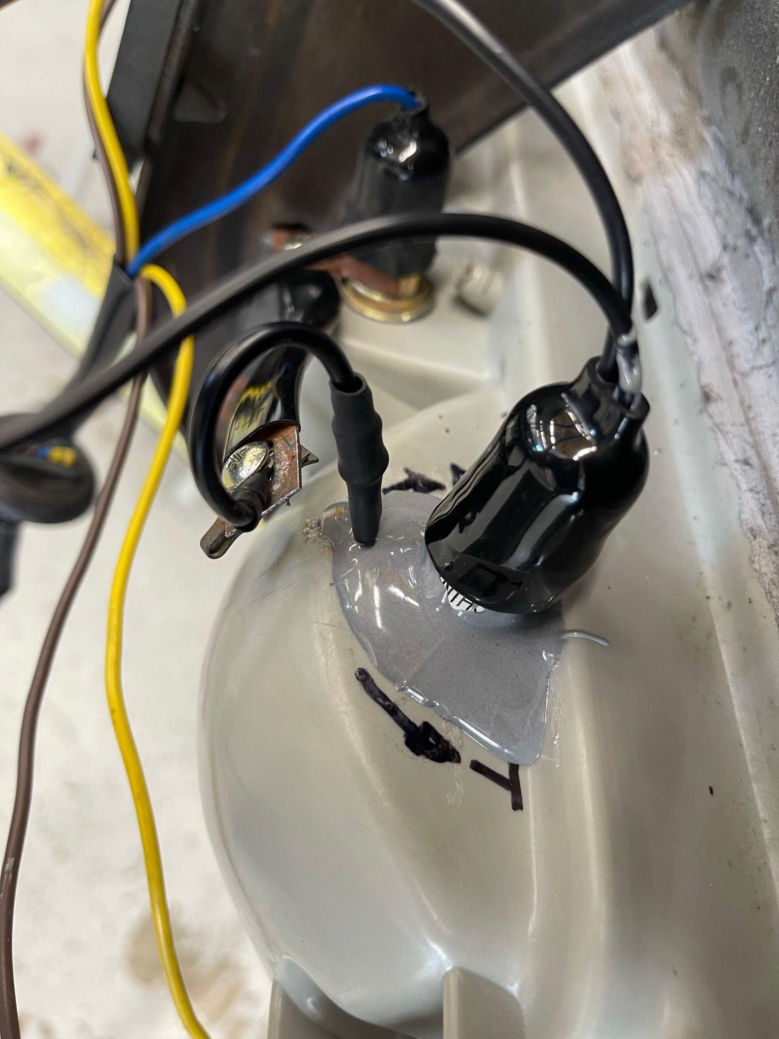 A bunch of wires are connected to a white object.