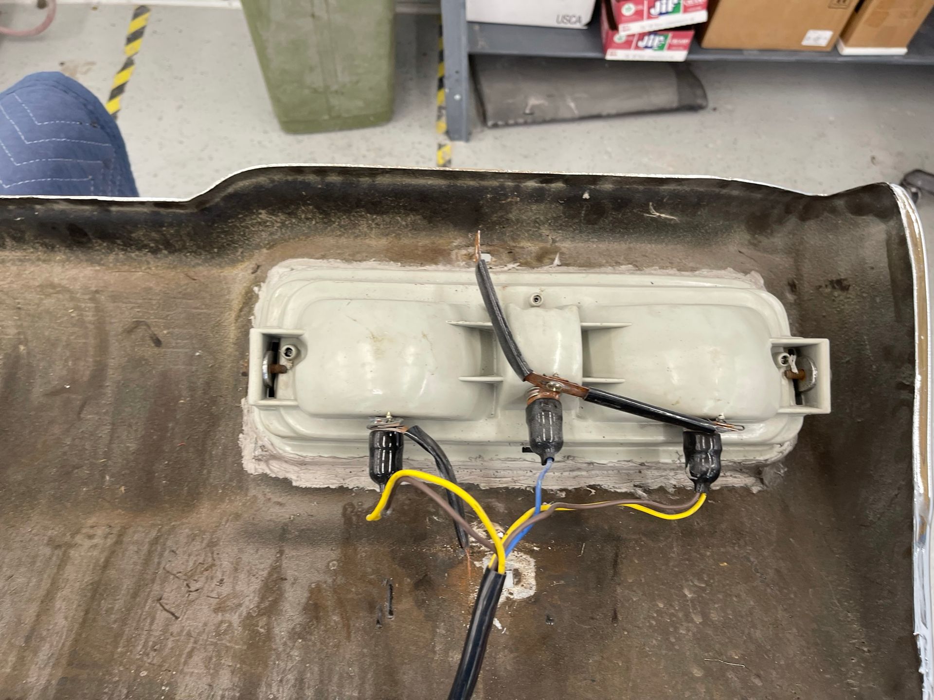 A close up of a car bumper with wires coming out of it.