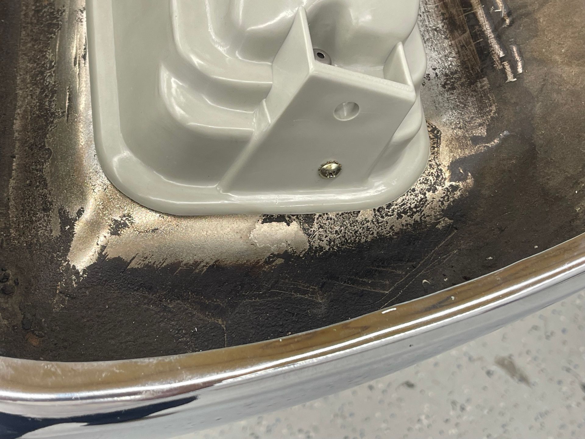 A close up of a metal surface with a white object on it