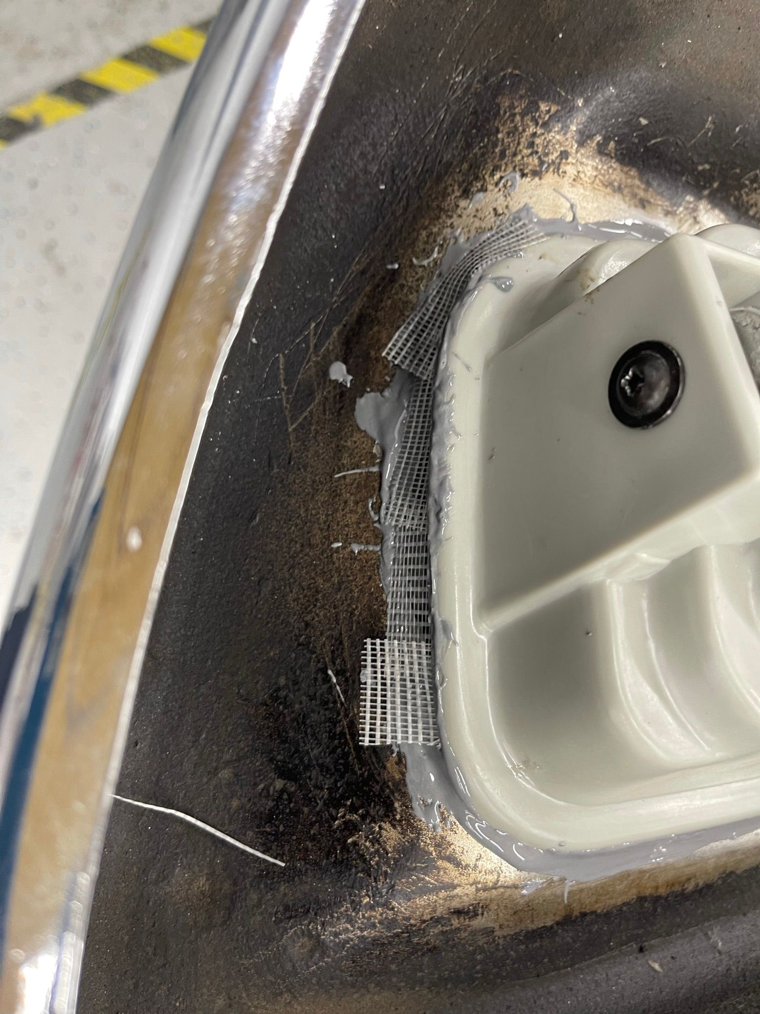 A close up of a sink with a hole in it.