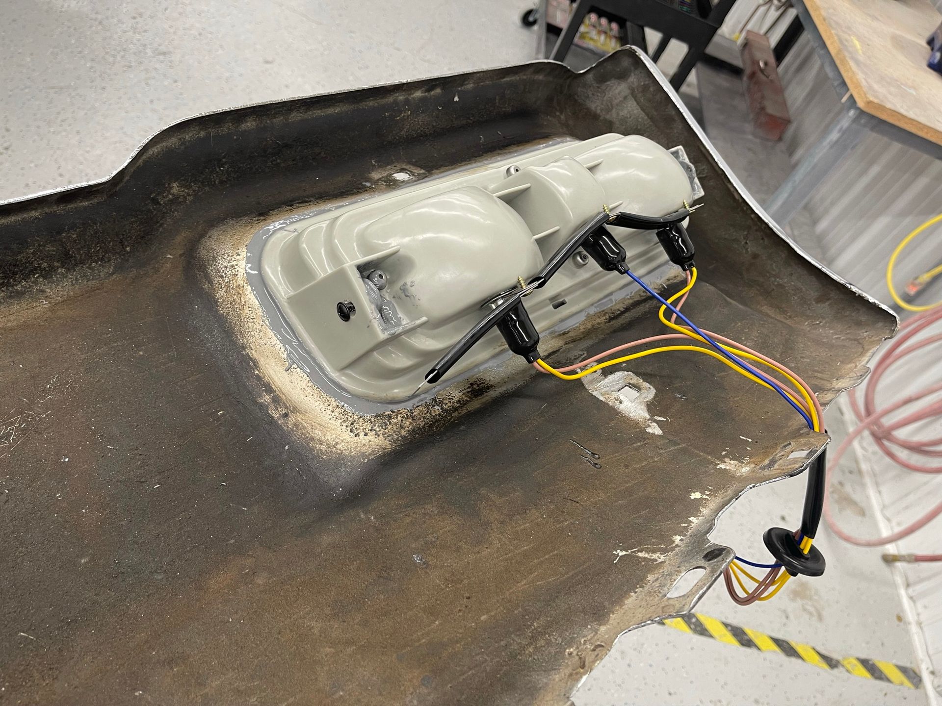 A car is being worked on with a bunch of wires coming out of it