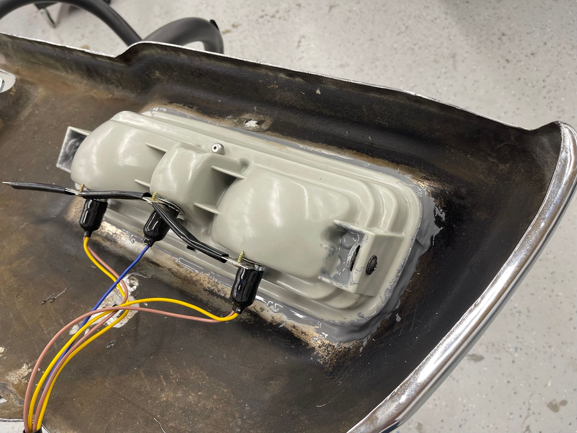 A close up of a bumper with wires coming out of it