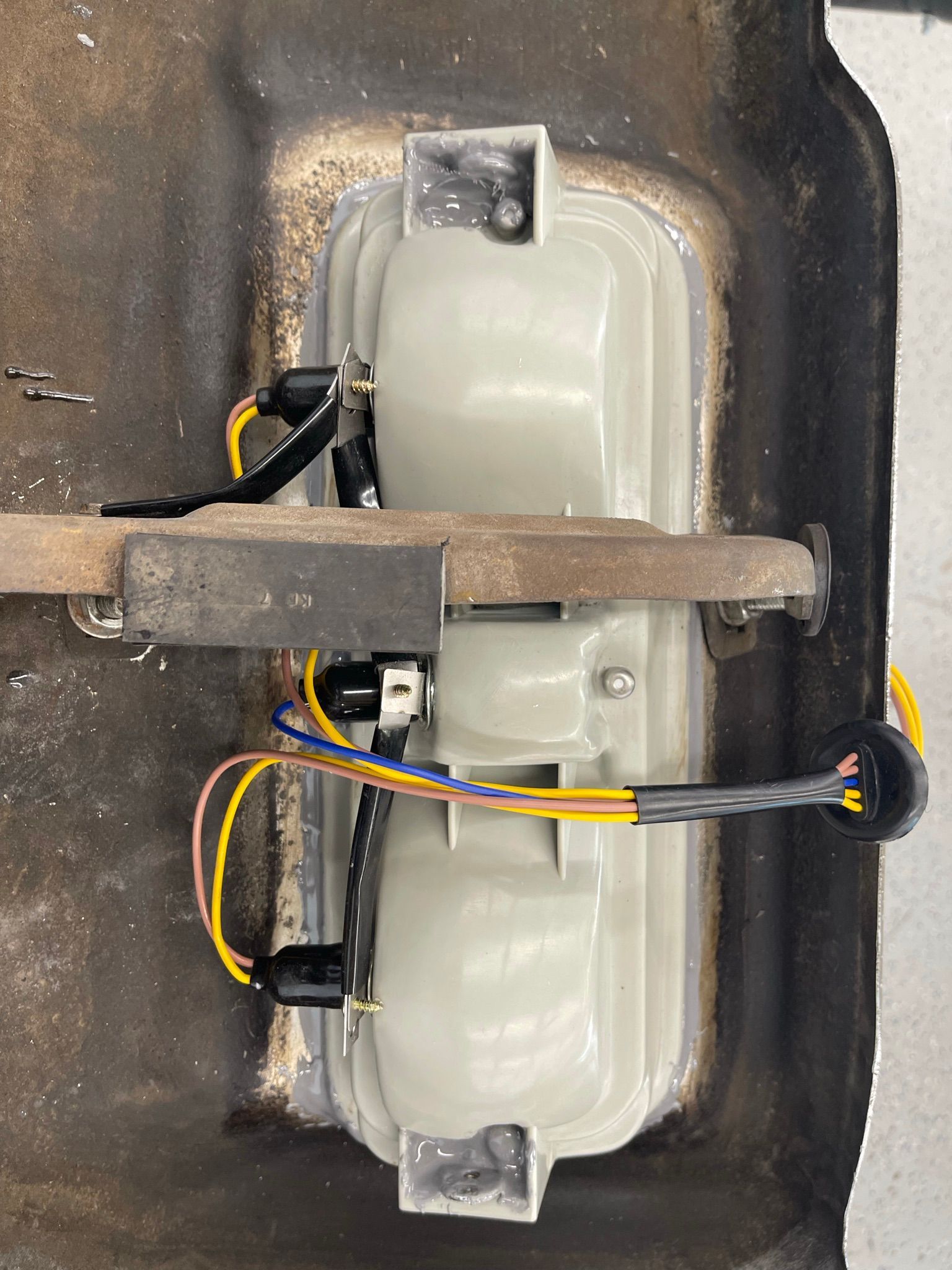 A close up of a light with wires coming out of it.