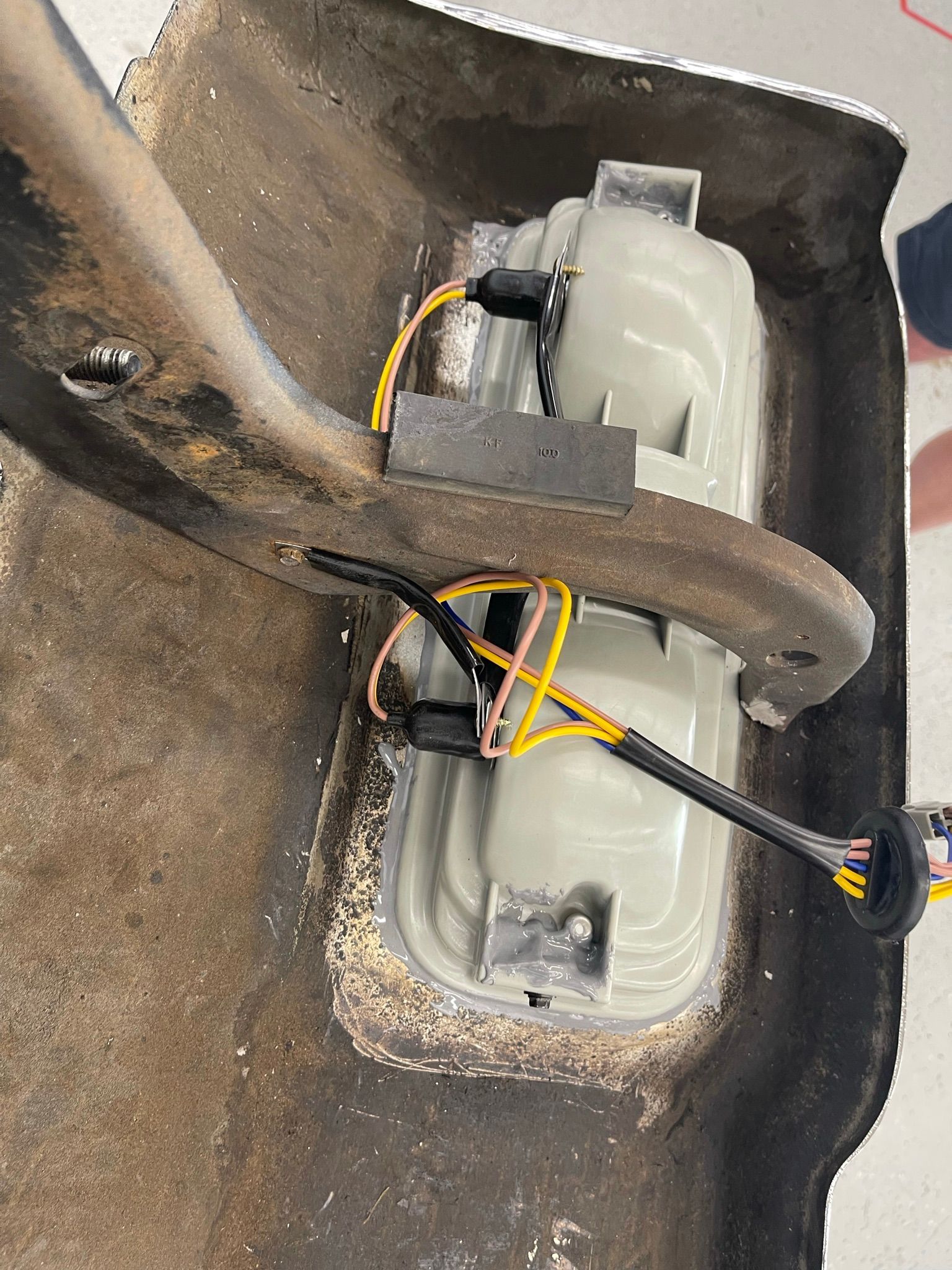 A close up of a light with wires coming out of it.