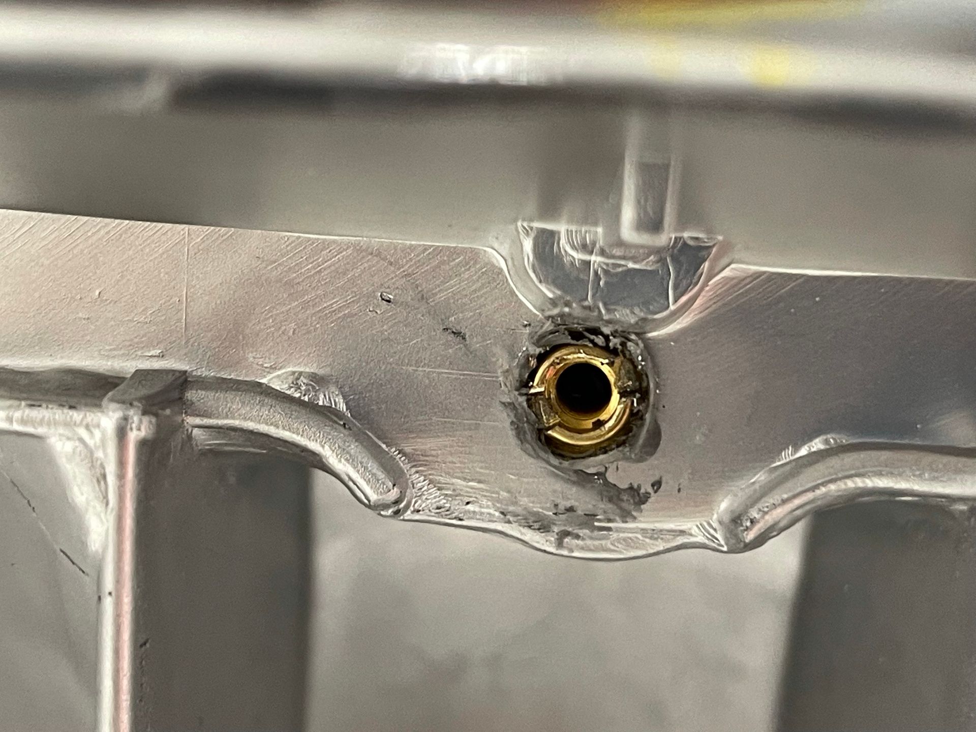 A close up of a metal object with a hole in it.