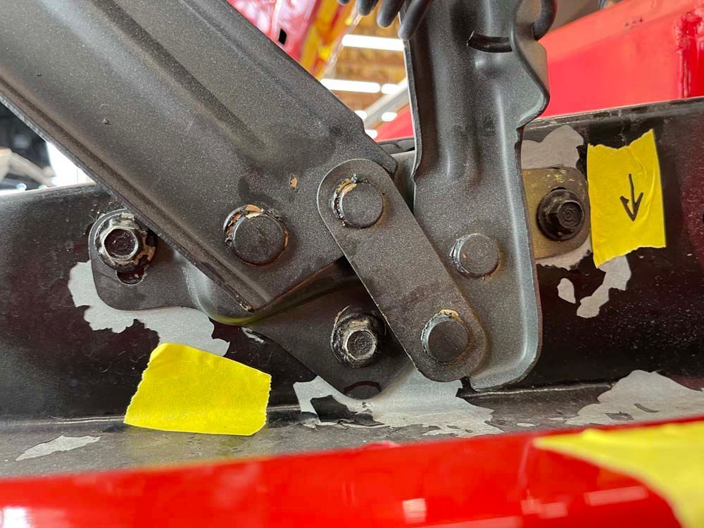 A close up of a piece of metal with a yellow arrow pointing down