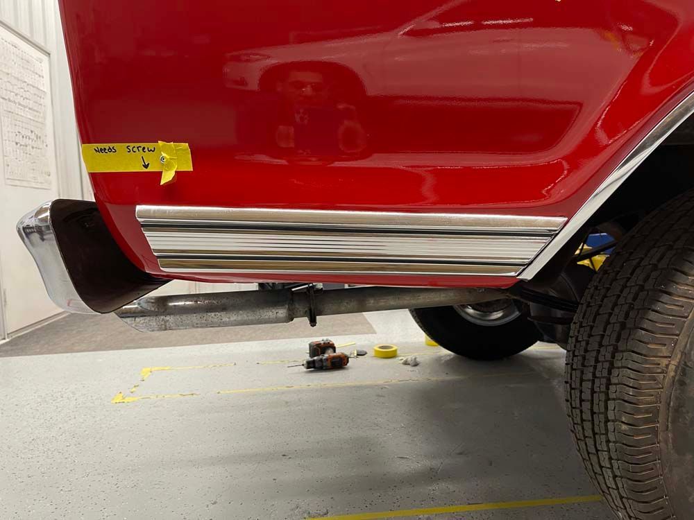 A red car with a yellow padlock on the door