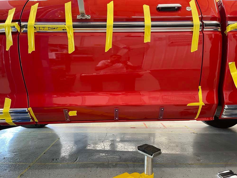 A red truck is taped to the side with yellow tape