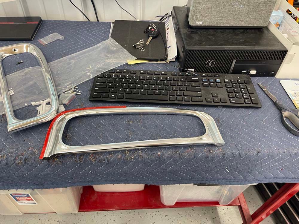 A desk with a keyboard , scissors , and other items on it.