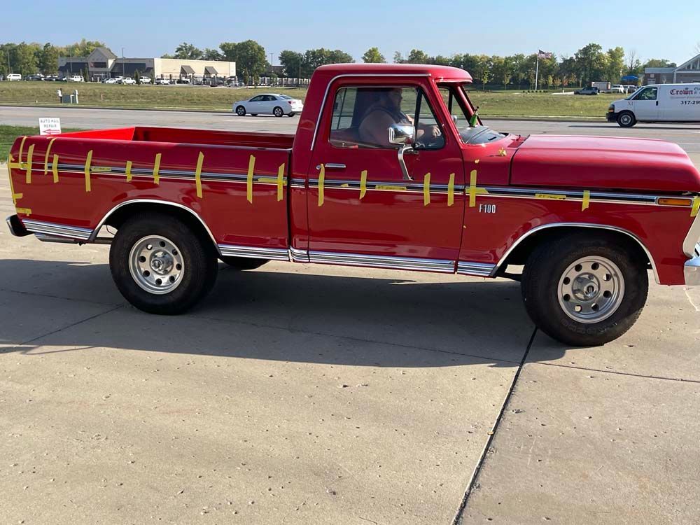 A red truck is parked on the side of the road.