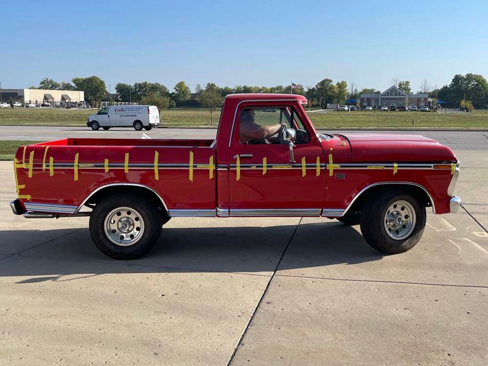 A red truck is parked on the side of the road