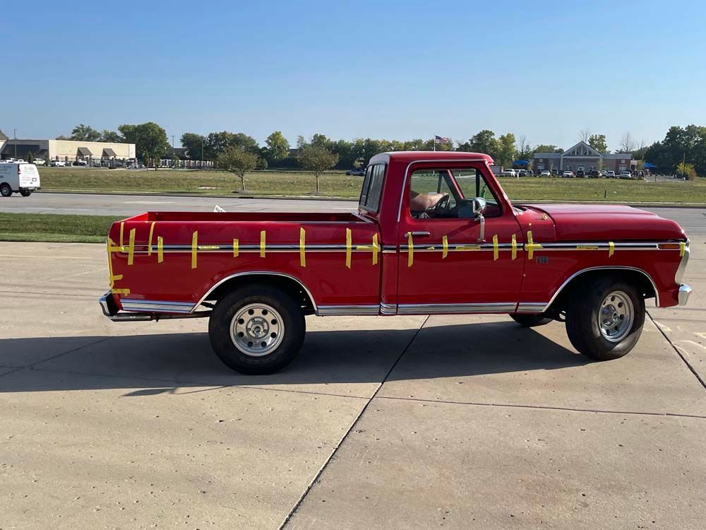 A red truck is parked on the side of the road.