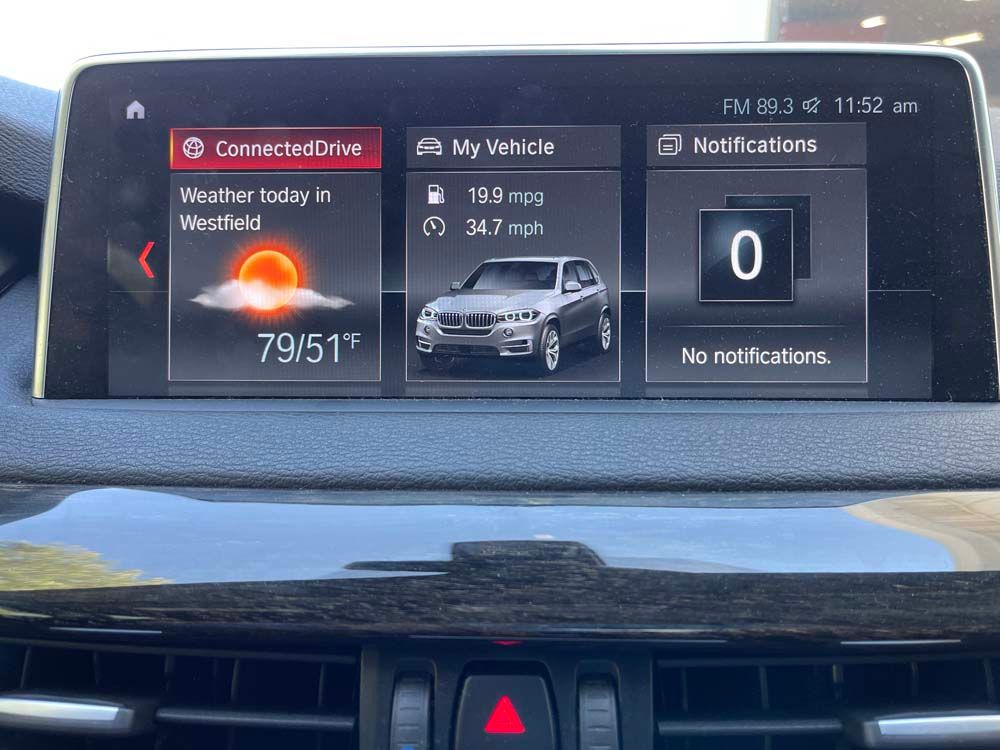 A car dashboard with a connected drive app on it