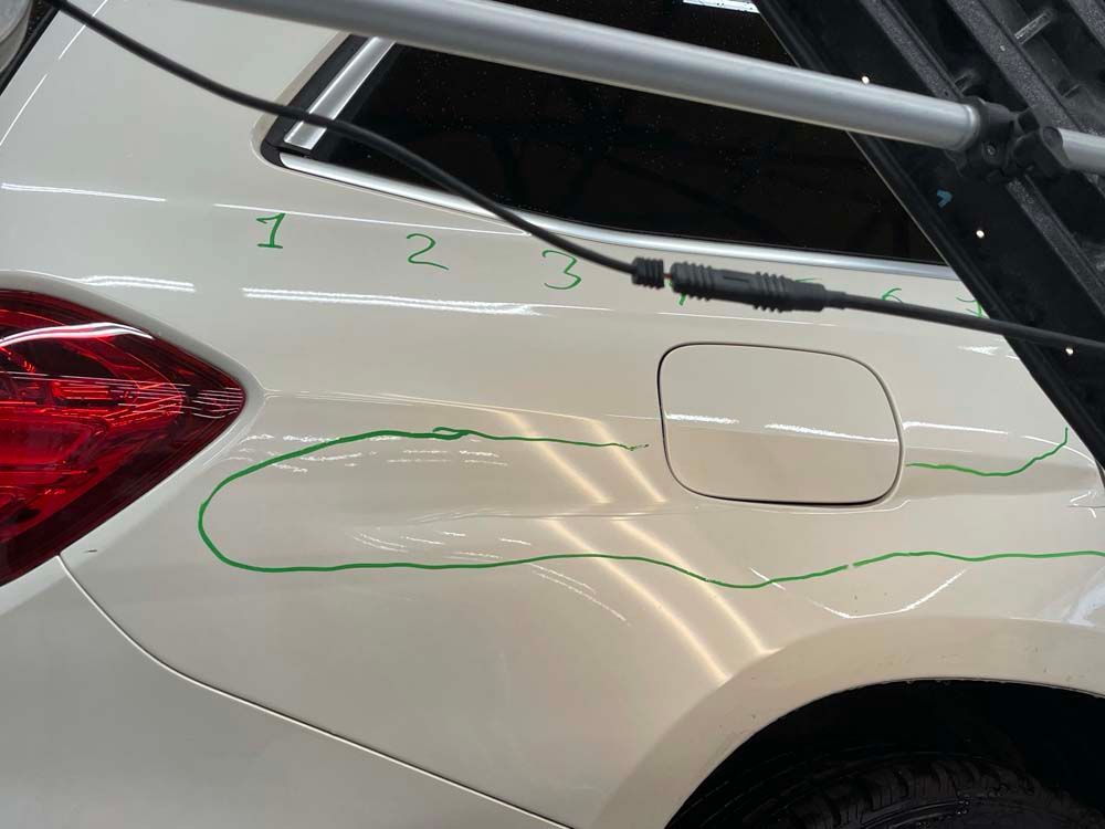 A white car with the number 1 2 and 3 written on it