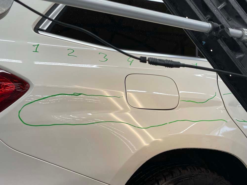 A white car with numbers 1 2 3 4 written on it