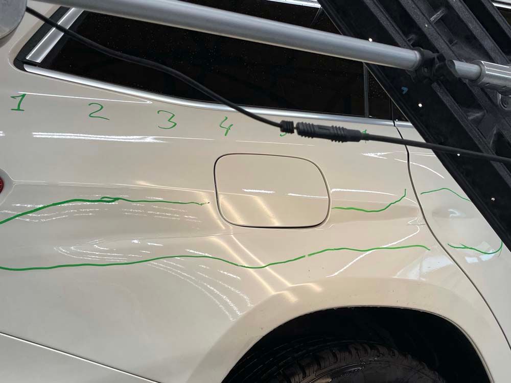 A white car with numbers 1 2 3 4 written on it