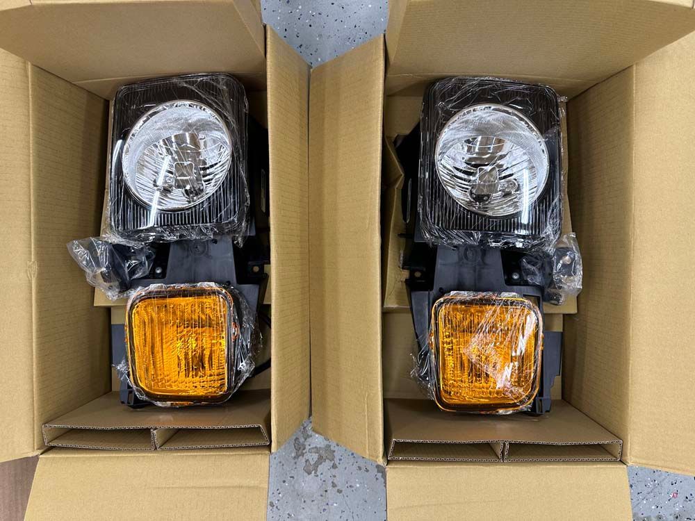 A pair of headlights are in a cardboard box