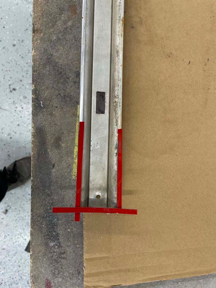 A piece of metal is sitting on top of a piece of cardboard.