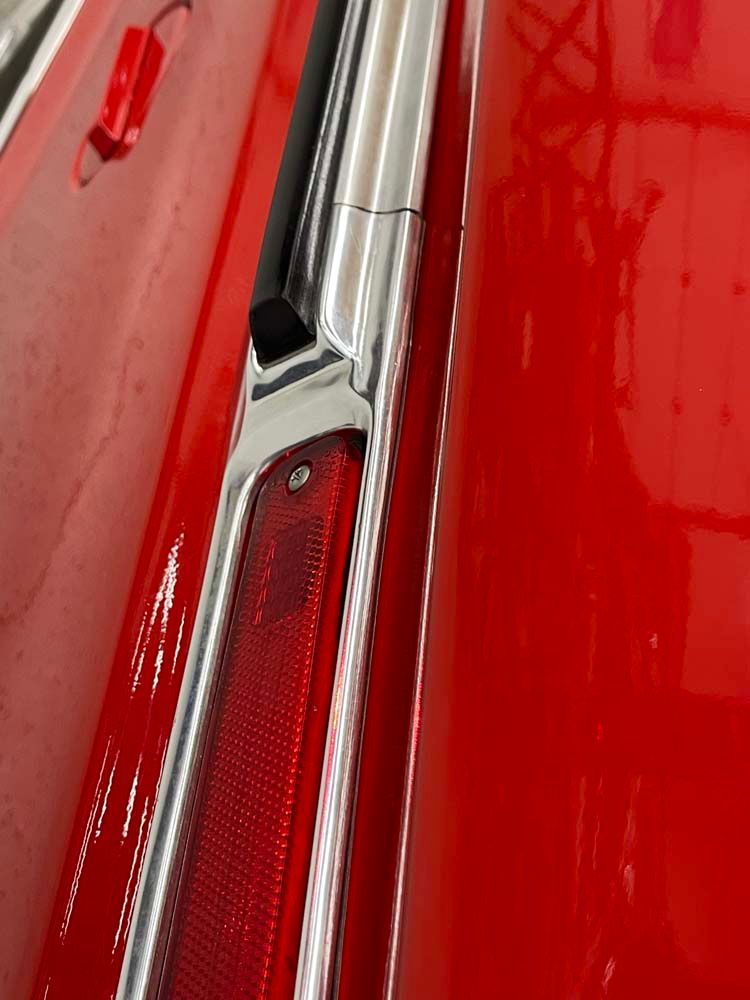 A close up of a red car 's tail light