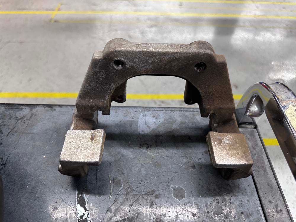 A metal object is sitting on top of a metal table.
