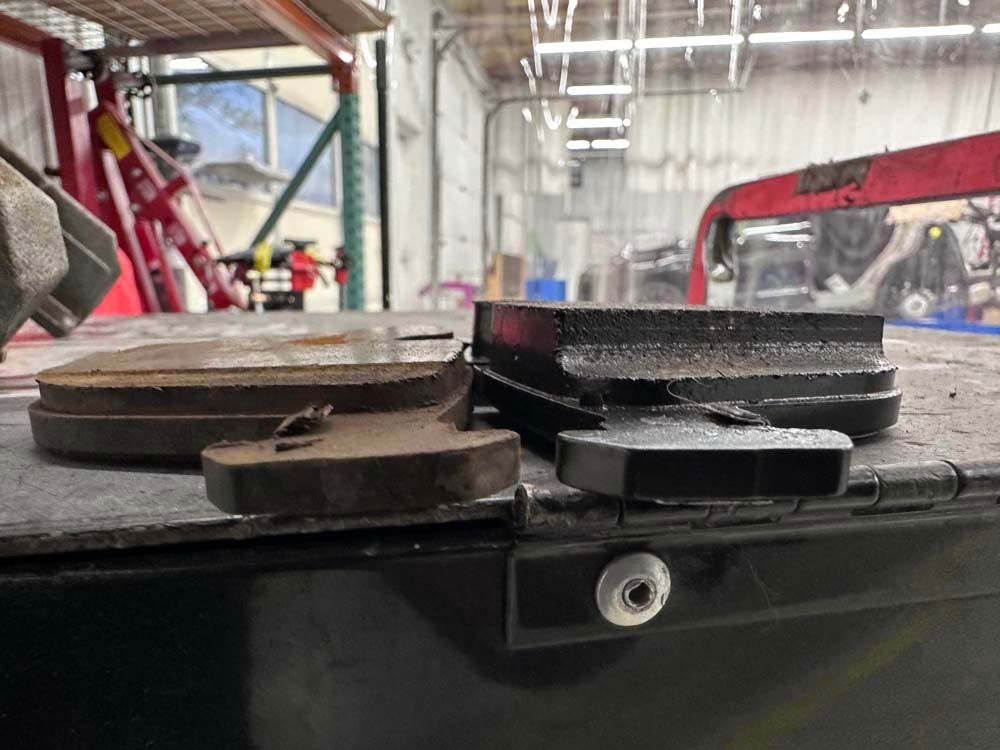 A pair of brake pads are sitting on the back of a truck.