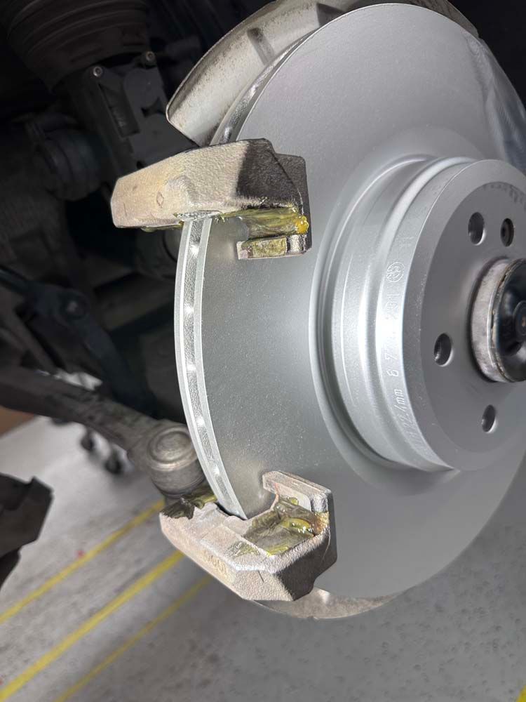 A close up of a brake disc on a car.