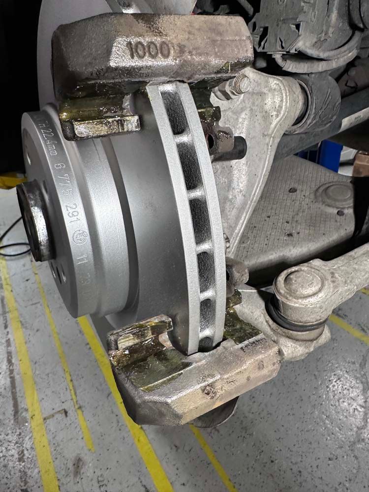 A close up of a brake caliper on a car.