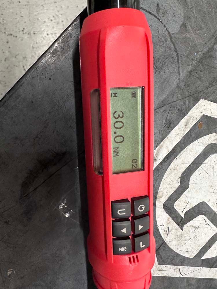 A red device that says 30.0 nm on the screen