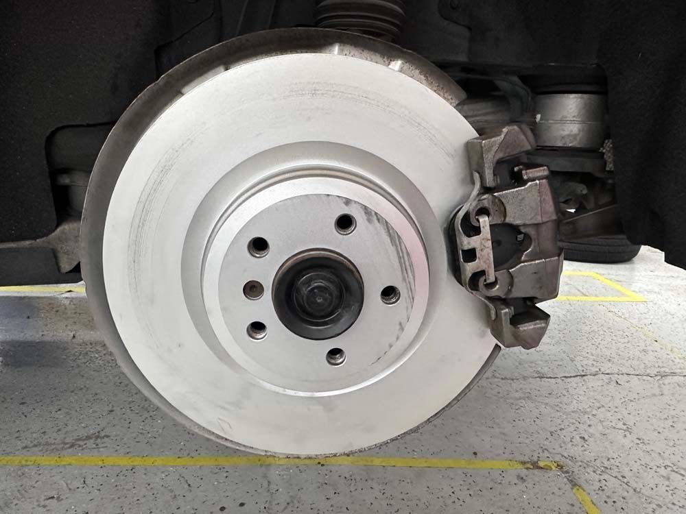 A close up of a brake disc on a car