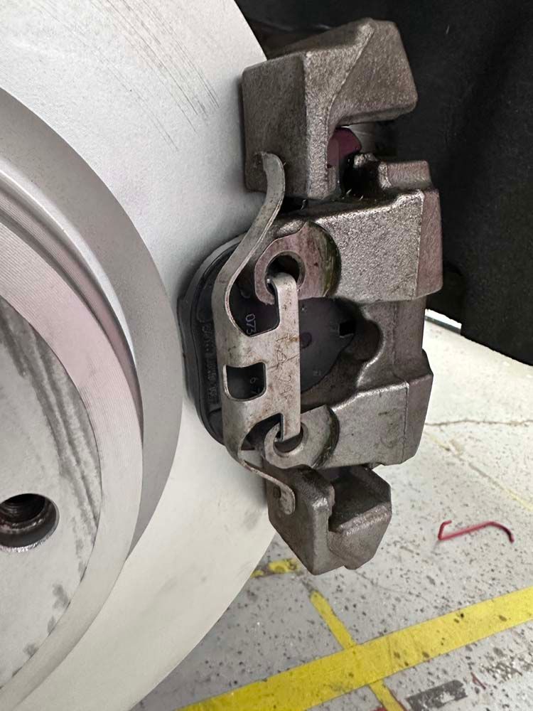 A close up of a brake caliper on a car wheel