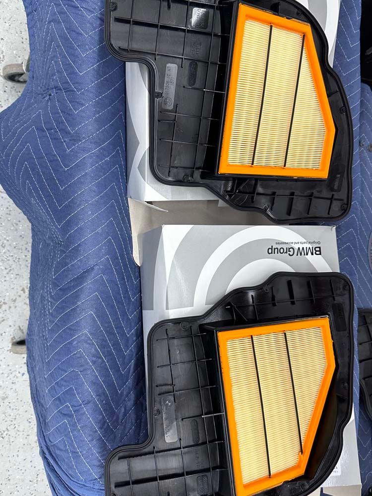 A pair of air filters are sitting on top of a blue blanket.