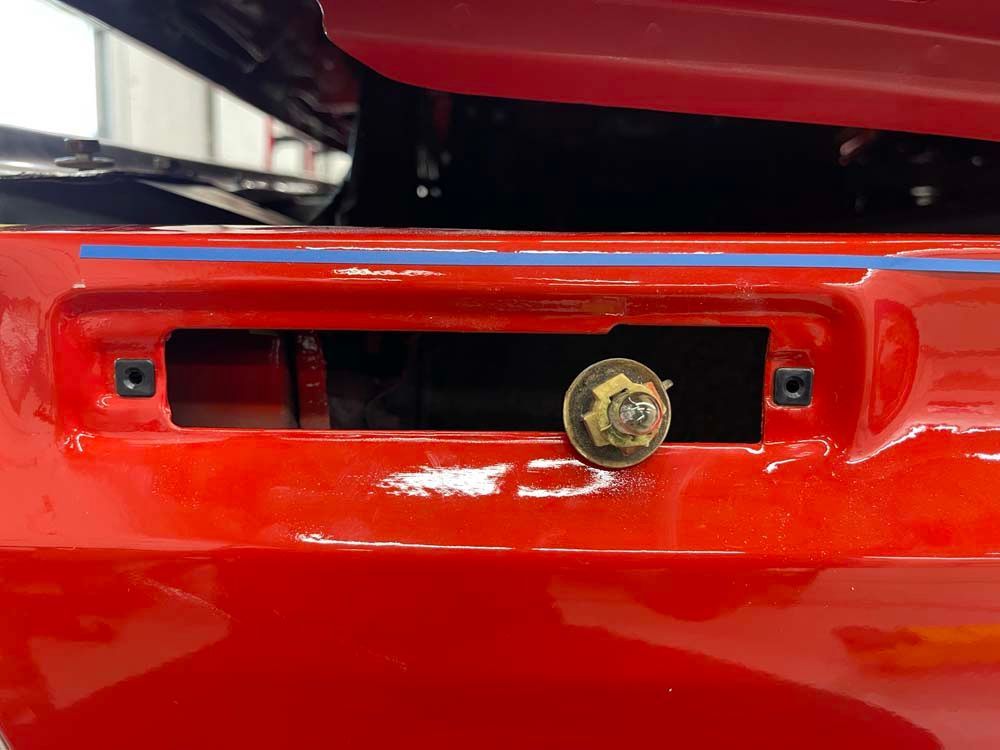 A close up of a red car with the hood open.