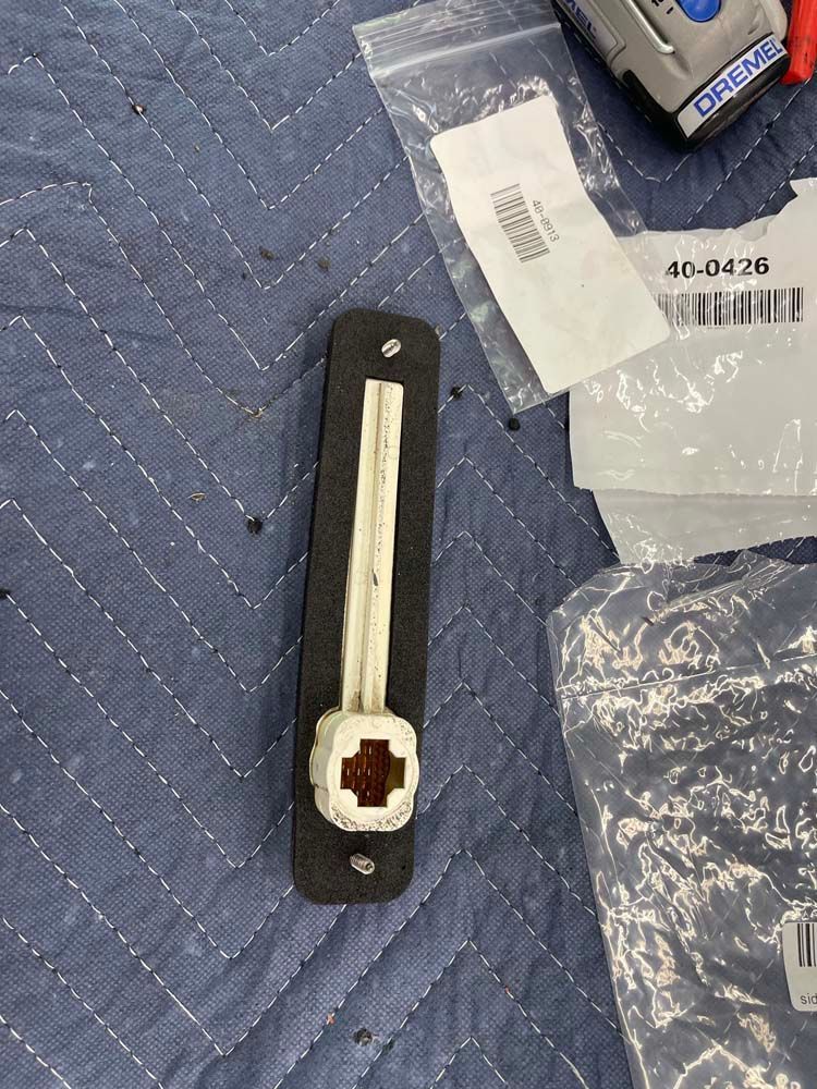 A piece of plastic is sitting on top of a blue quilt.