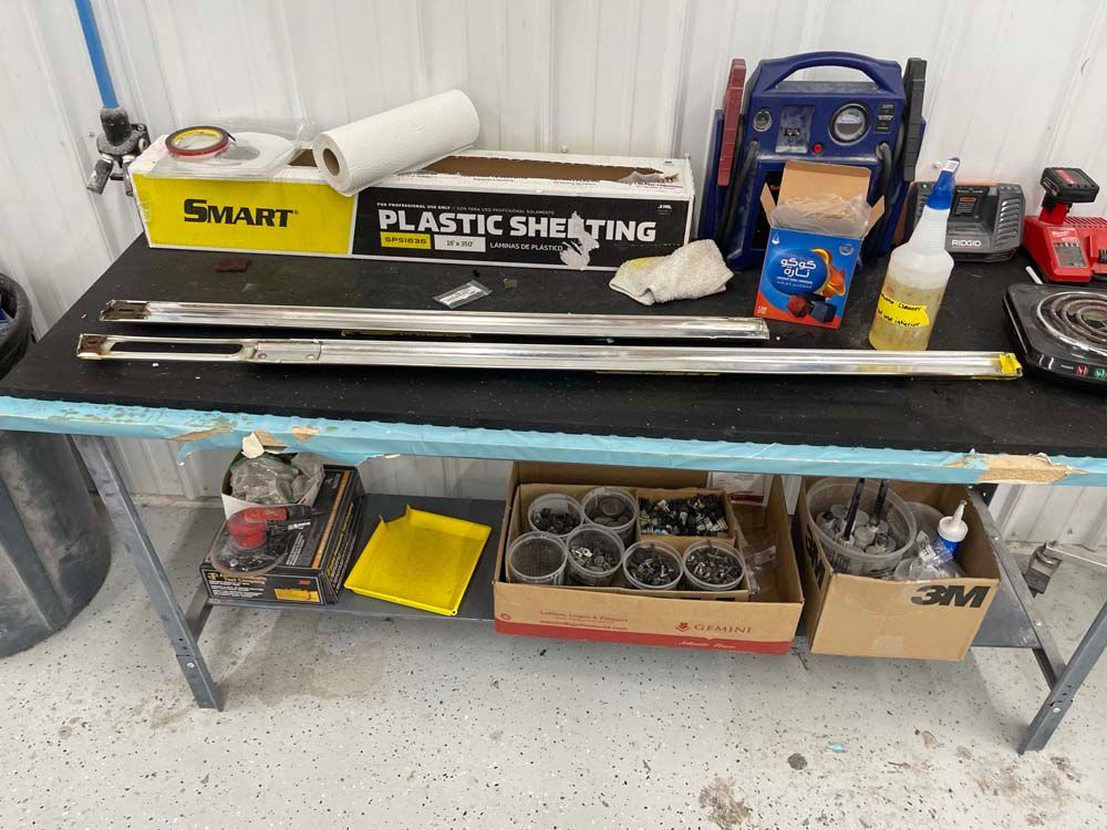 A table with a box of plastic sheeting on it.