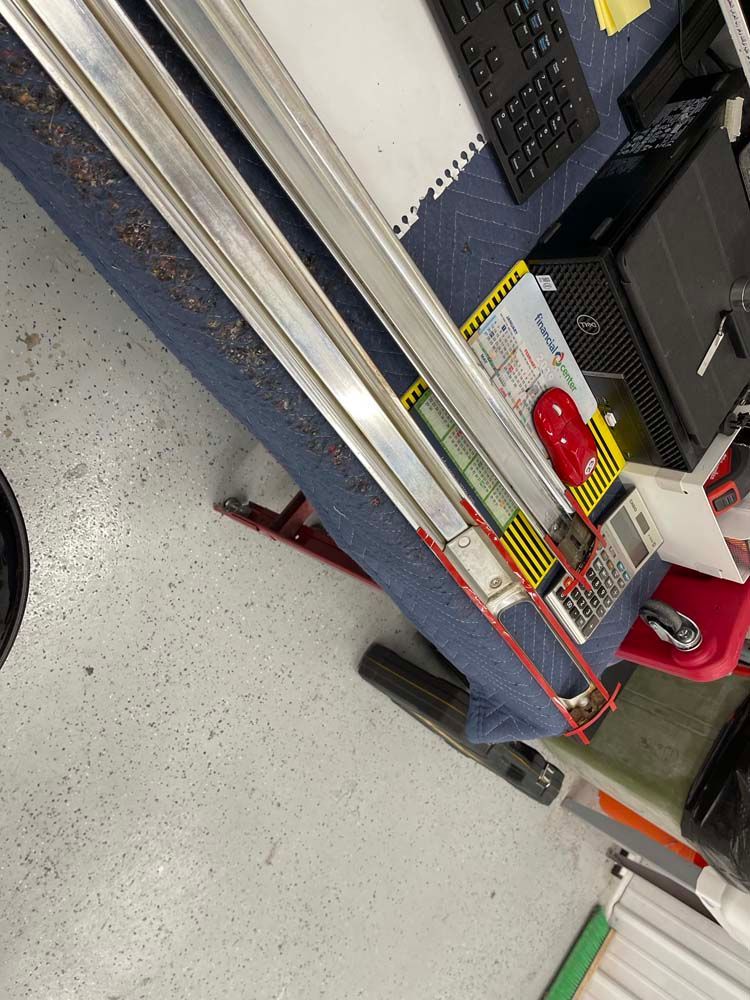 A thermometer is sitting on a table next to a computer.