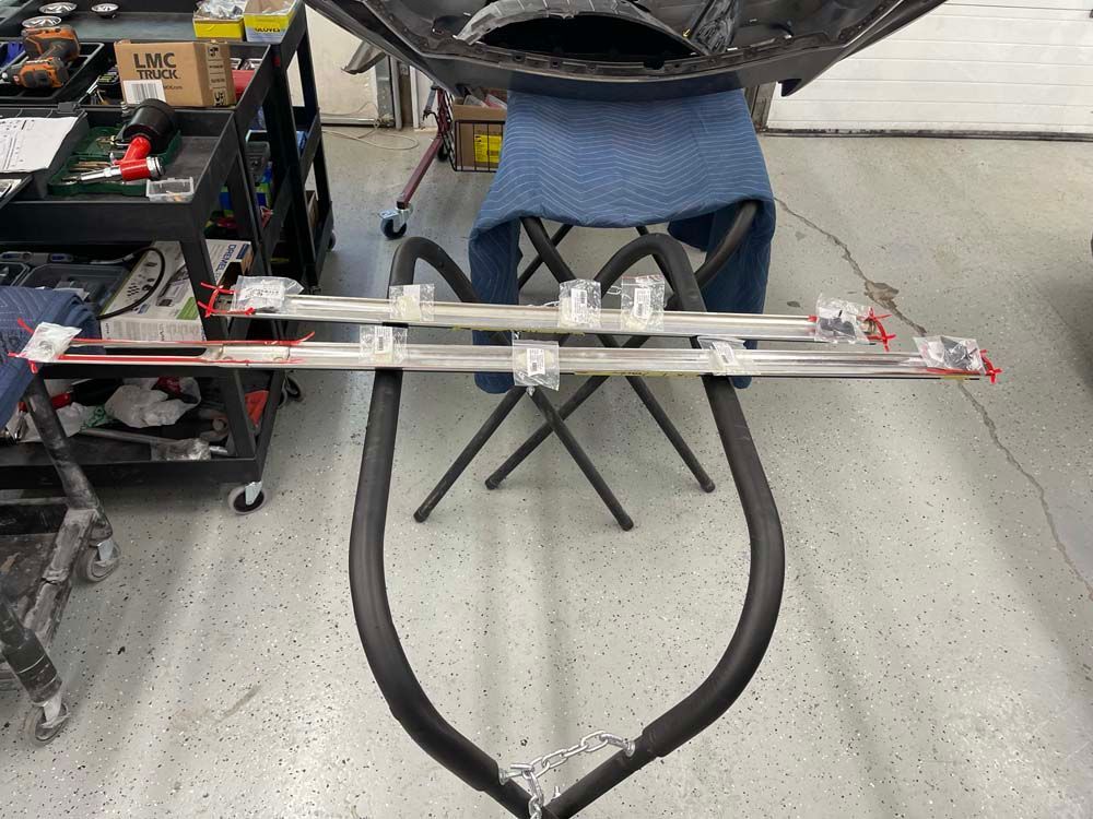 A bunch of pieces of metal are sitting on a table in a garage.