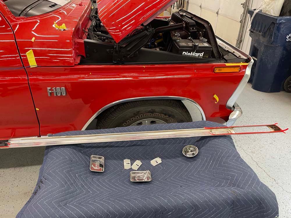 A red ford truck is sitting on a blue blanket