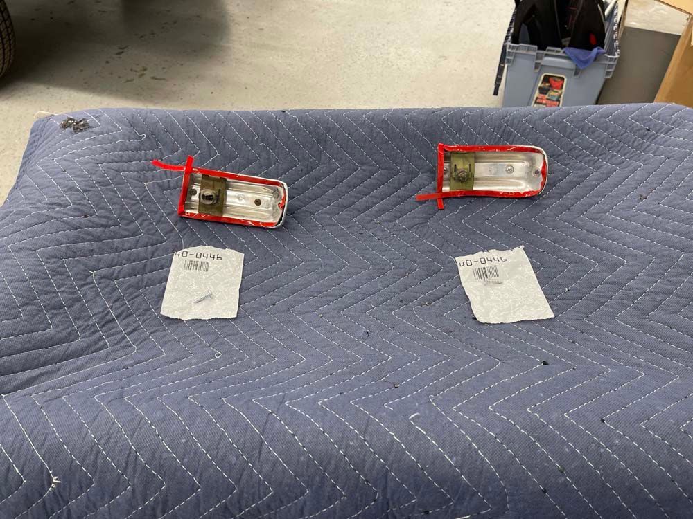 Two pieces of metal are laying on a blue blanket