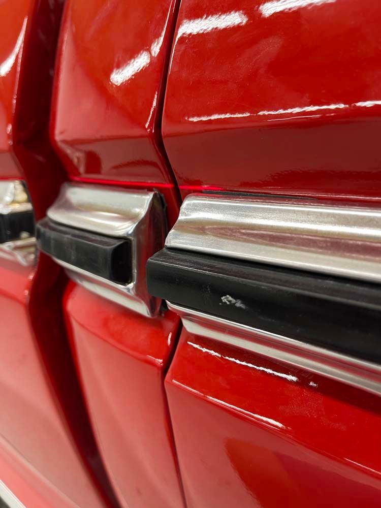 A close up of the side of a red car