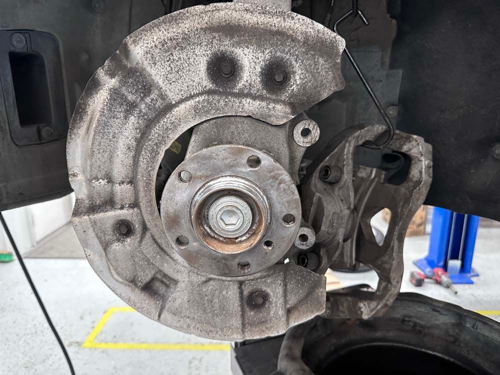 A close up of a brake disc on a car.