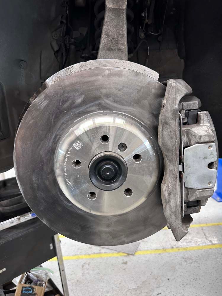 A close up of a brake disc on a car.