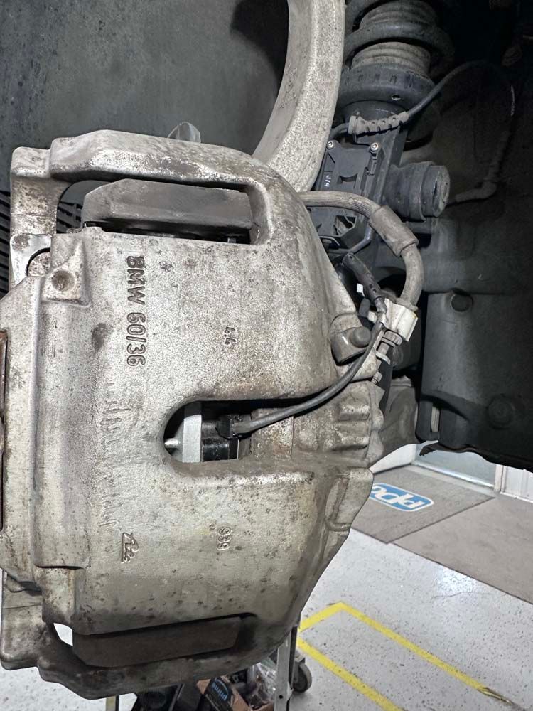 A close up of a brake caliper on a car.