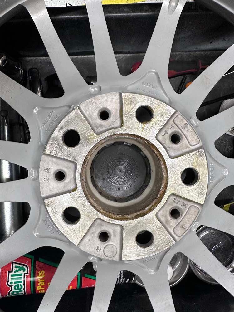 A close up of a car wheel with holes in it.