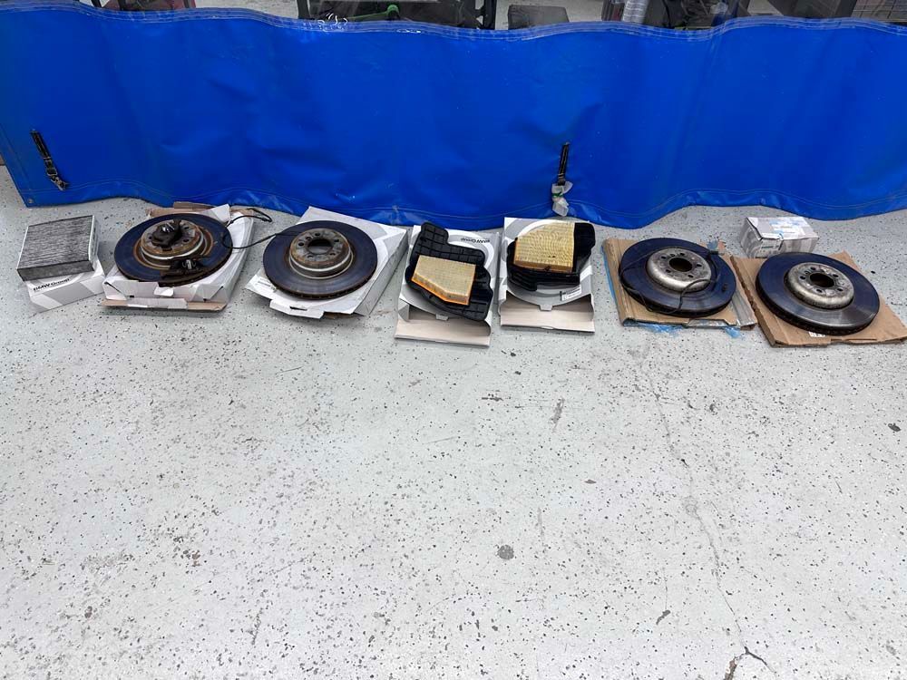 A bunch of brake rotors are lined up on a table