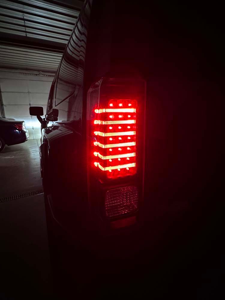 A close up of a truck 's tail light in a garage.