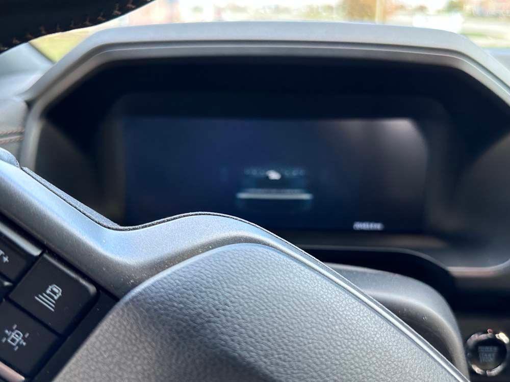 A close up of the steering wheel and dashboard of a car