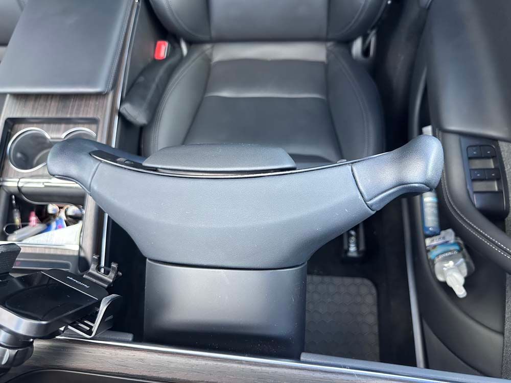 A steering wheel is sitting in the center console of a car.