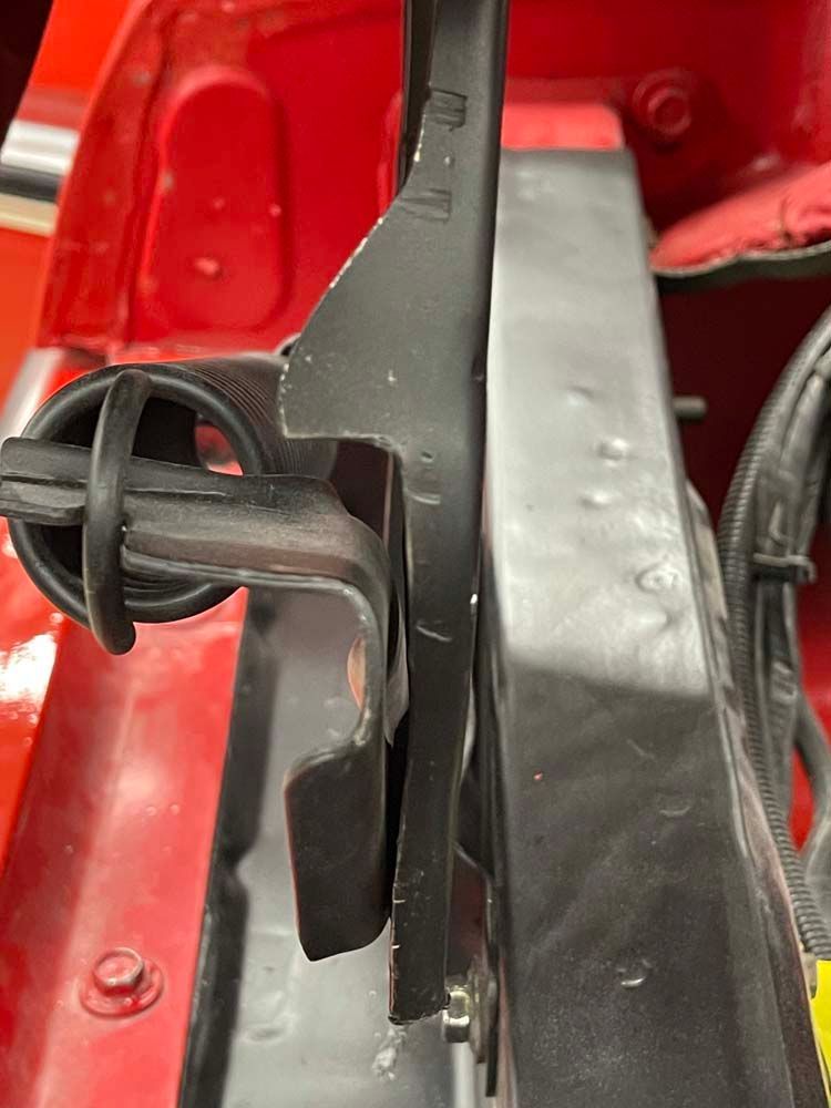 A close up of a radiator on a red car.