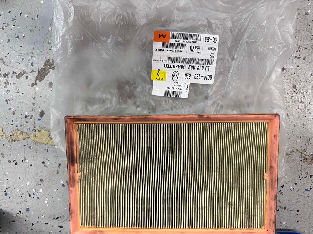 A copper air filter with a yellow label on it