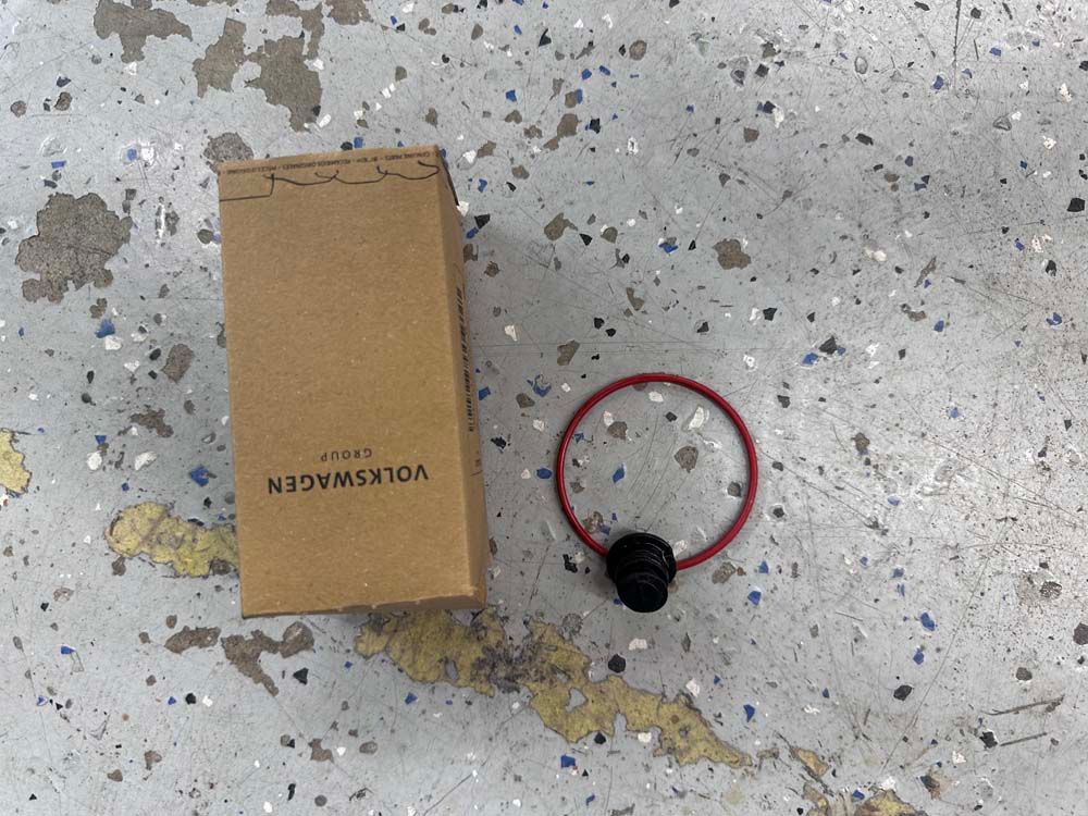 A volkswagen box sits next to a red bracelet